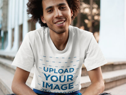 Tee Mockup of a Young Man in Front of a Building
