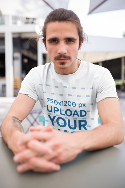 Mockup of a Handsome Man Wearing a Tee at a Restaurant