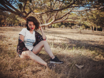 Tee Mockup of an Attractive Woman Sitting in a Field