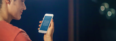 Mockup of a Man Using an iPhone 6 at a Recording Studio