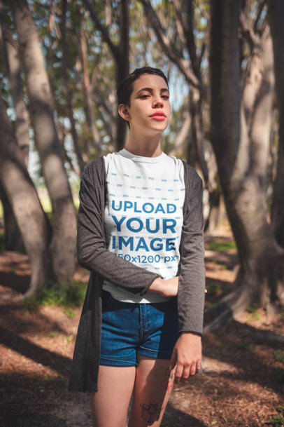 Mockup of a Woman with a Pixie Cut Wearing a Camping T-Shirt Outdoors