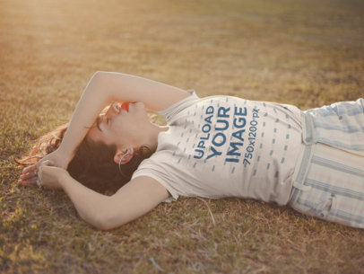 Mockup Featuring a Beautiful Woman Wearing a Tee Lying on Grass 19684