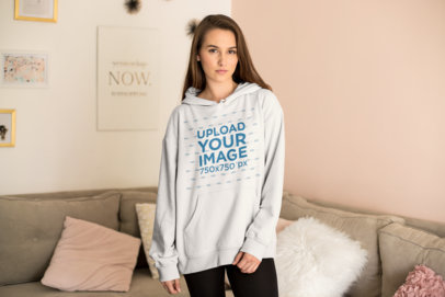 Cute Hoodie Mockup Featuring a Young Woman in Her Living Room