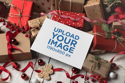 Mockup of a Christmas Card over Gift Boxes and Red Decorations