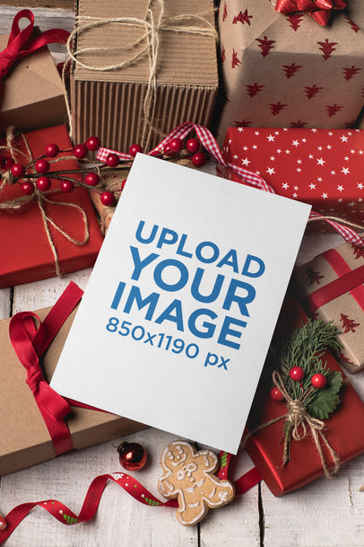 Christmas Card Mockup Lying Over Gifts and Ornaments