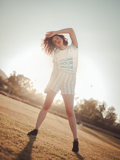 Camping T-Shirt Mockup of a Beautiful Woman Posing Against the Sunlight