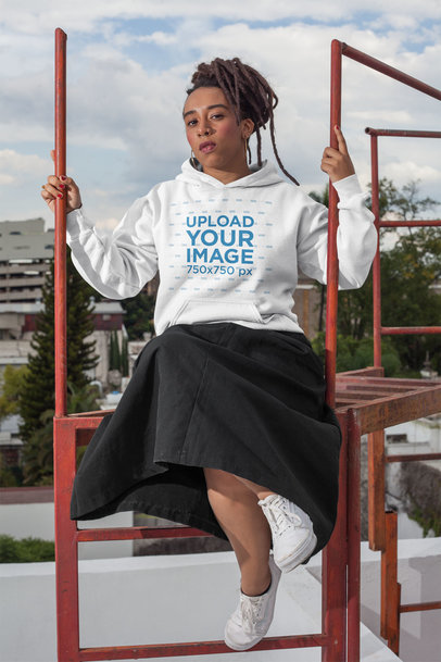 Hoodie Mockup of a Trendy Woman with Locs Wearing a Black Skirt on a Rooftop 23418