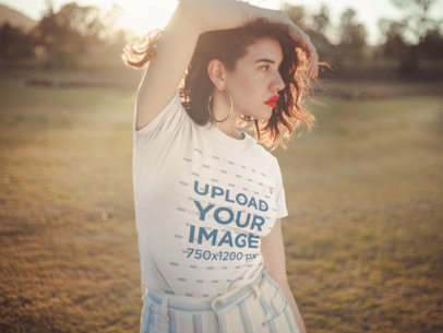 T-Shirt Mockup Featuring a Stylish Woman Posing Outdoors
