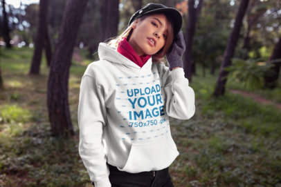 Mockup Featuring a Cool Woman Outdoors Wearing a Warm Hoodie