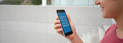 Mockup of a Young Man Using His iPhone 6 While Walking