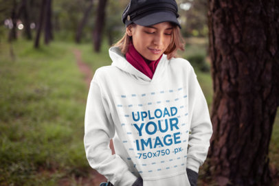 Mockup of a Beautiful Young Woman Wearing a Hoodie and a Trendy Kepi Hat