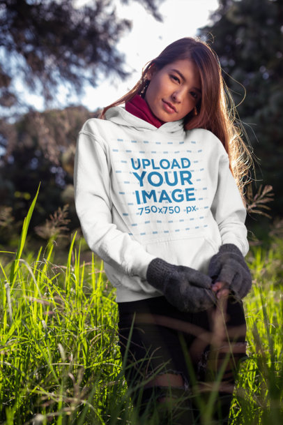Pullover Hoodie Mockup Featuring a Beautiful Young Woman in the Field 