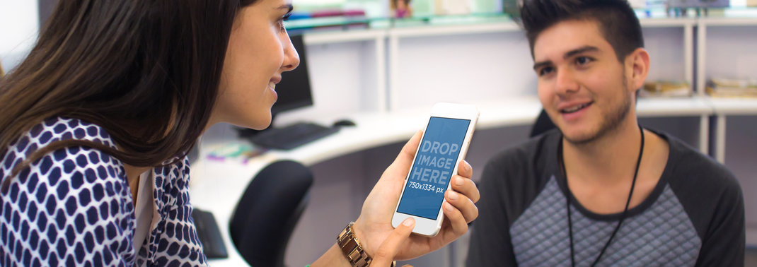 iPhone Mockup of a Young Woman Talking to a Coworker at the Office