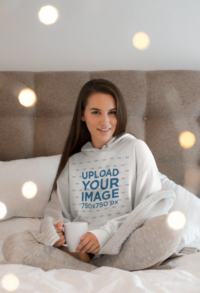 Hoodie Mockup of a Woman Surrounded by Twinkly Lights