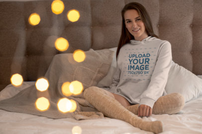 Mockup of a Young Woman Wearing a Hoodie and Long Socks in Her Room