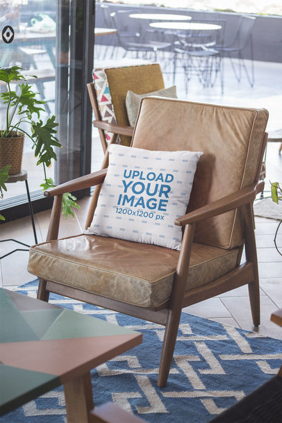 Mockup of a Pillow on a Leather Armchair