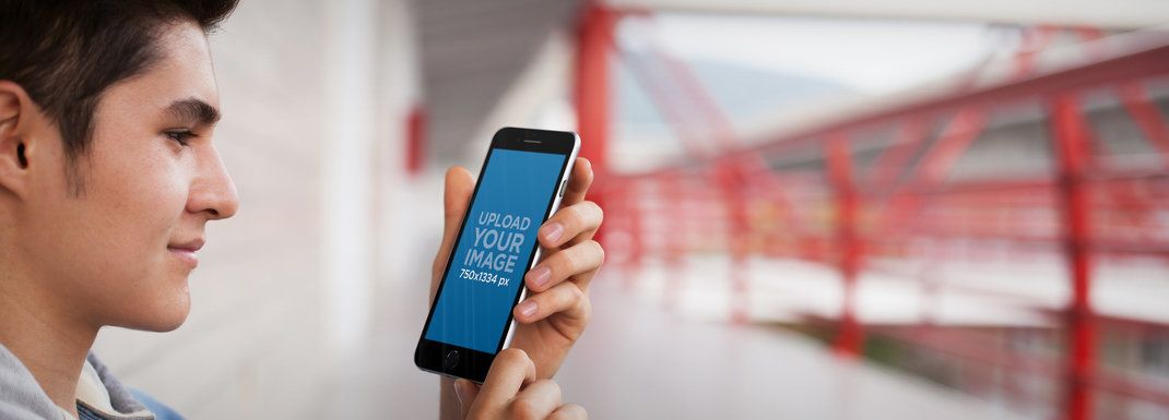 iPhone 6 Mockup Template of a Young Man at the University
