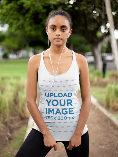 Mockup of a Woman Wearing a Racerback Tank Top at a Park