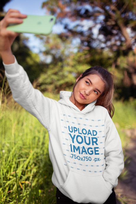 Pullover Hoodie Mockup of a Woman Taking a Selfie at the Countryside