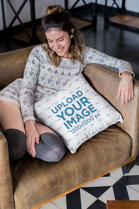 Pillow Mockup of a Smiling Woman Sitting on a Sofa
