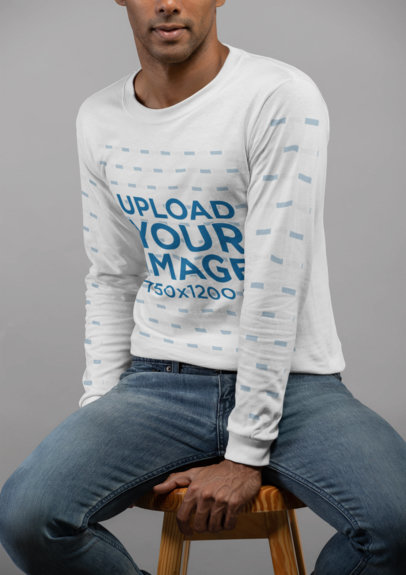 Mockup of a Man Wearing a Long Sleeve Tee Sitting on a Stool