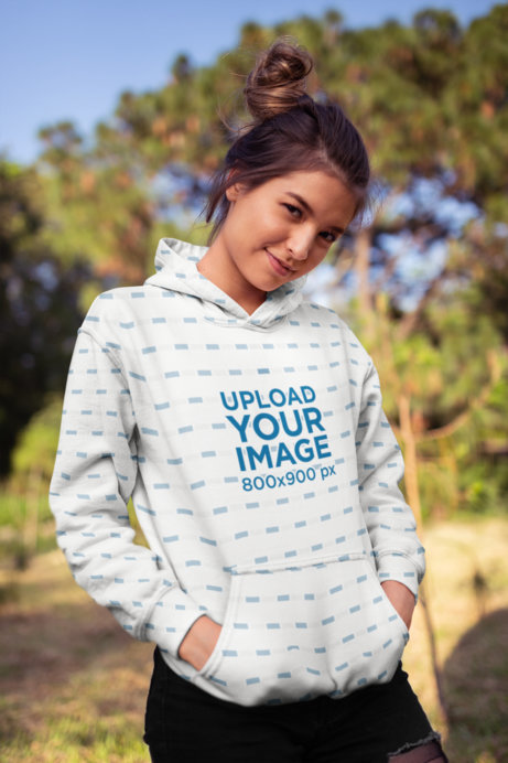 Mockup Featuring a Cute Woman Wearing a Hoodie in the Park