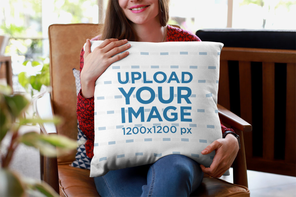 Mockup of a Smiling Woman Holding a Pillow