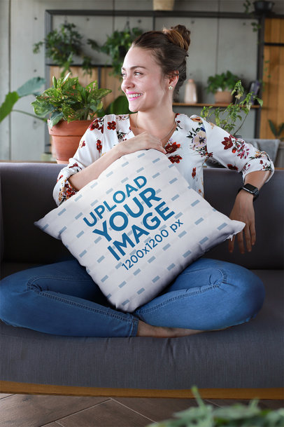 Mockup of a Smiling Woman Holding a Pillow at a Lounge