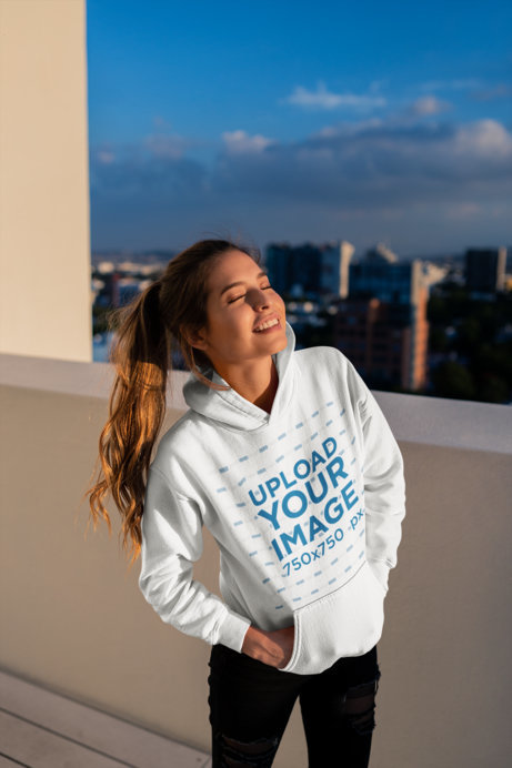 Hoodie Mockup of a Smiling Woman at a Building's Rooftop