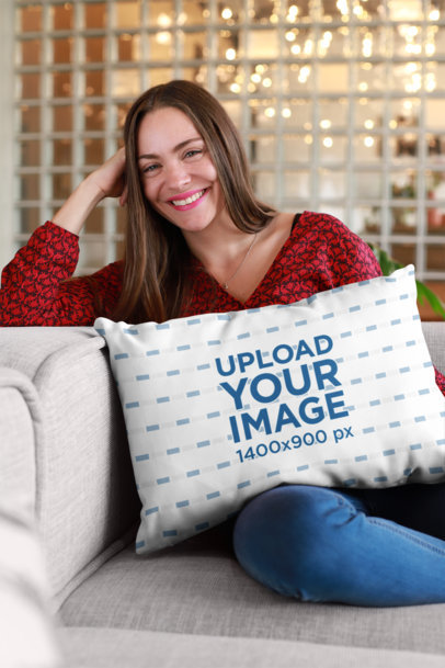 Mockup of a Smiling Woman Sitting with a Pillow on Her Lap
