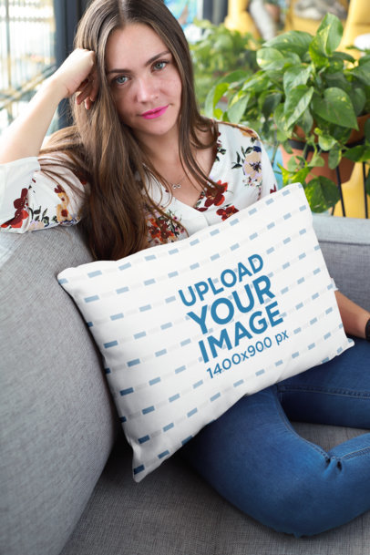 Pillow Mockup of a Woman Sitting on a Sofa