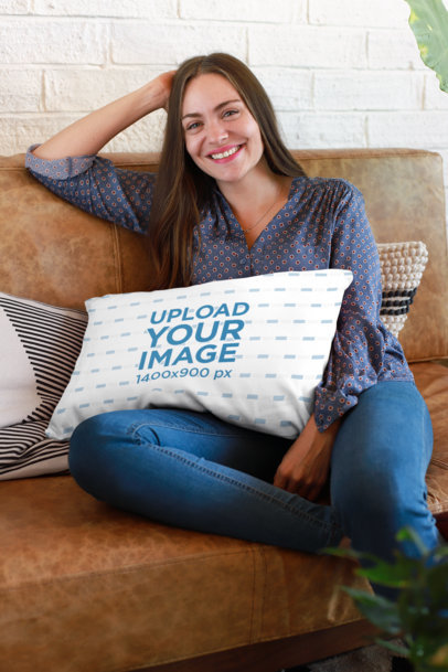 Pillow Mockup of a Woman Relaxing on a Leather Coach with a Pillow on Her Lap