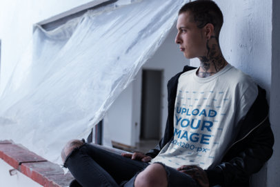 T-Shirt Mockup of a Punk Man with Tattoos at the Construction Site
