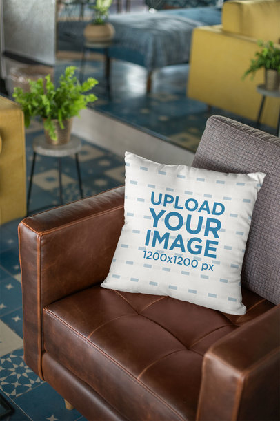 Throw Pillow Mockup Lying Over a Retro Leather Couch