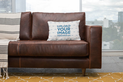 Mockup of a Pillow on a Sofa with the City on the Background