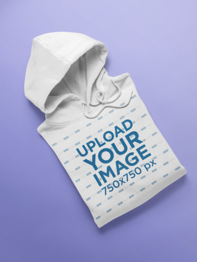 Folded Pullover Hoodie Mockup on a Solid Surface
