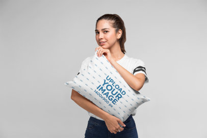 Pillow Mockup of a Beautiful Woman Hugging a Pillow in a Studio