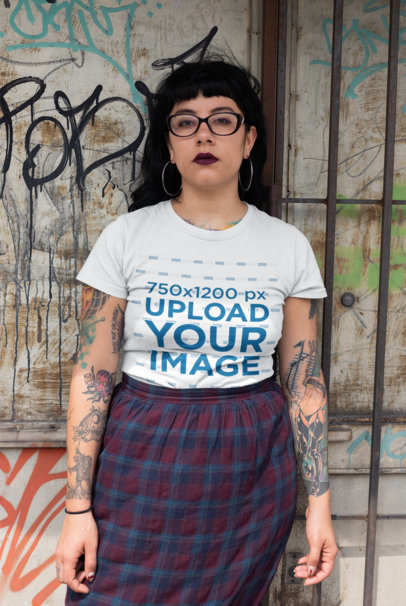 T-Shirt Mockup of a Punk Woman Standing Against an Urban Wall