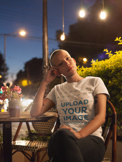 T-Shirt Mockup of an Alternative Woman Sitting in Coffee Shop At Night