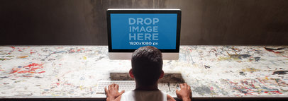 iMac Mockup of a Young Man at a Creative Studio