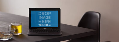 Laptop Mockup Featuring an Asus Laptop on Top of a Dinner Table