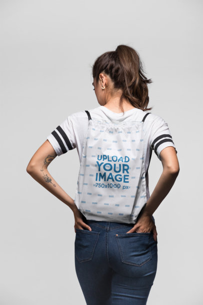 Mockup of a Woman Carrying a Drawstring Bag on Her Back 23662
