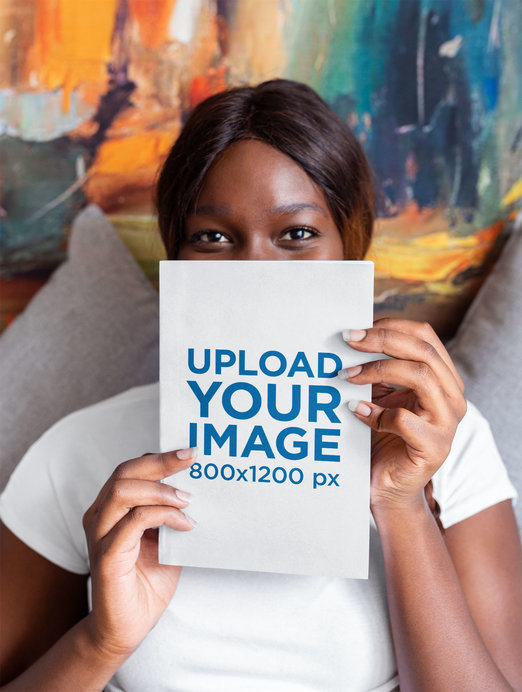 Mockup of a Woman Holding a Book Up to Her Face
