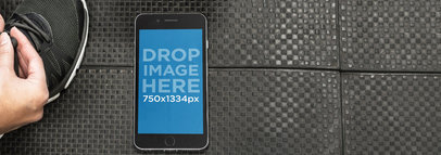 iPhone Mockup of a Woman at the Gym Tying her Shoelaces a4813