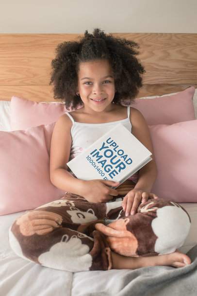 Mockup of a Cute Girl With an Afro Holding a Book to Her Chest