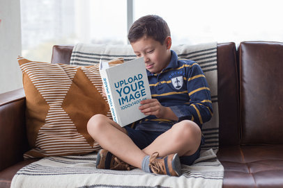 Mockup of an Attentive Young Boy Reading a Book