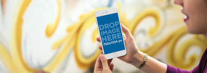 Young Woman at an Art Gallery Using an iPhone 6 Mockup