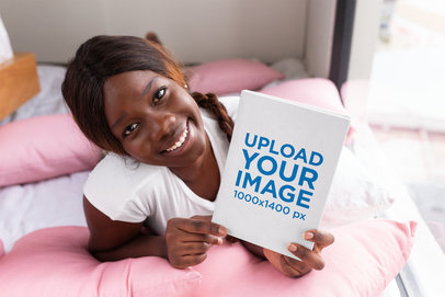 Book Mockup of a Smiling Woman on Her Bed