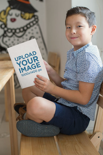 Back to School Book Mockup of a Little Boy Reading and Smiling