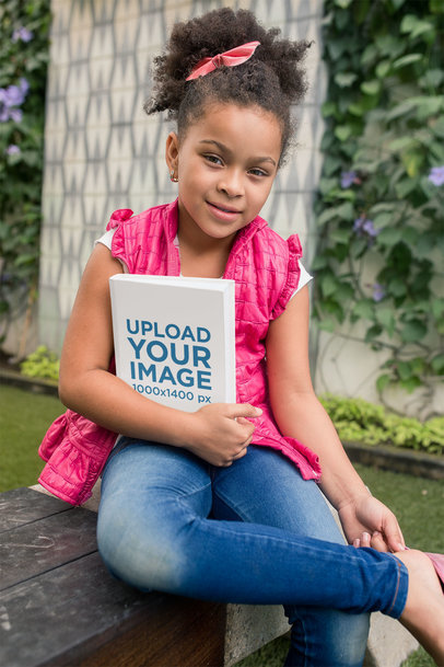 Back to School Mockup of a Little Girl Holding a Book in Her Backyard